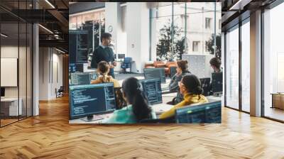 Teacher Giving Lesson to Diverse Multiethnic Group of Female and Male Students in College Room. Class Learning About Computer Science and Software Development. Lecturer Shares Knowledge with Scholars Wall mural