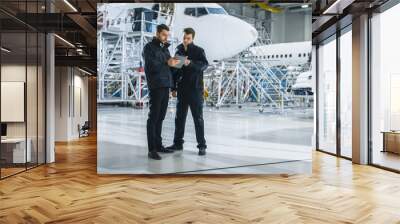 Team of Aircraft Maintenance Mechanics Looking at Airplane Wall mural