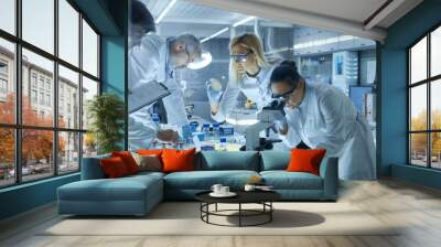 Team of Medical Research Scientists Work on a New Generation Disease Cure. They use Microscope, Test Tubes, Micropipette and Writing Down Analysis Results. Laboratory Looks Busy, Bright and Modern. Wall mural