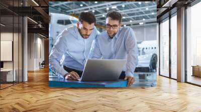 Two Aircraft Mechanics Working and Having Conversation next to Laptop Computer Wall mural