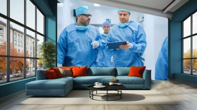 Two Doctors Walking Through Hospital and Discussing Comeing Operation.One Use Tablet in Hands. Wall mural