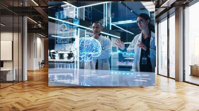 Two Neuroscientists Working With Computer-Powered VFX Hologram Of Human Brain And Nervous System In Futuristic Laboratory. Multiethnic Man And Woman Working On Technological Solutions for Brain Tumor. Wall mural