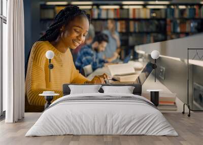 University Library: Gifted Black Girl uses Laptop, Writes Notes for the Paper, Essay, Study for Class Assignment. Diverse Multi-Ethnic Group of Students Learning, Studying for Exams, Talk in College Wall mural