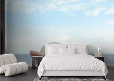 Back view of elegant lady relaxing on a chaise lounge, sandy beach outdoors background Wall mural