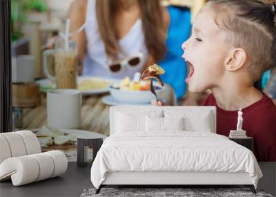 boy eating pancake with banana and chocolate Wall mural