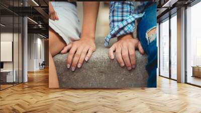 Hands of young couple in love close side by side on the first date Wall mural