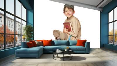 Muslim boy with Koran isolated on white background Wall mural