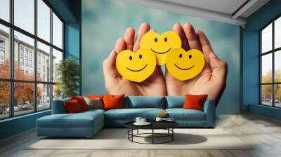 Female hands holding yellow paper cut heart happy smile faces, positive thinking, or mental health assessment , world mental health day concept Wall mural