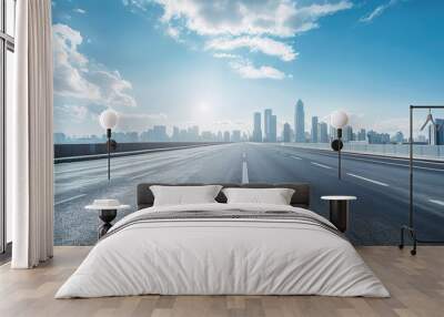 A sunny road surface under the background of modern urban skyline Wall mural