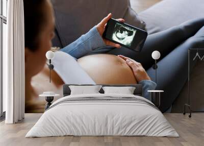  Pregnat woman chcecing online medical scans Wall mural