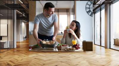 Caucasian couple enjoying lunch together at home Wall mural