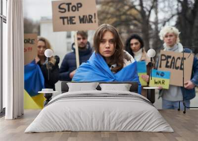 Group of young caucasian people manifesting against war in Ukraine Wall mural