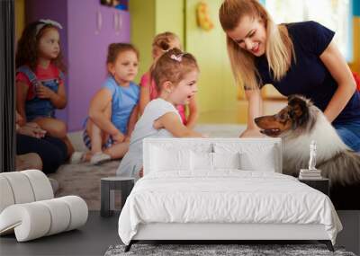 Happy child playing with dog Wall mural