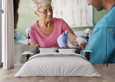 Senior woman with bandage on the hand Wall mural