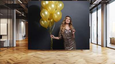 Woman with balloons and champagne looking at copy space Wall mural