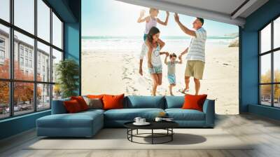 Parents, children and beach for high five happy or summer travel vacation, ocean sunshine or family development. Man, woman and kids on sand for holiday relax walking or outdoor, clean air or smile Wall mural