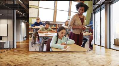 The art of teaching is the art of discovery. a teacher in a classroom with her students. Wall mural