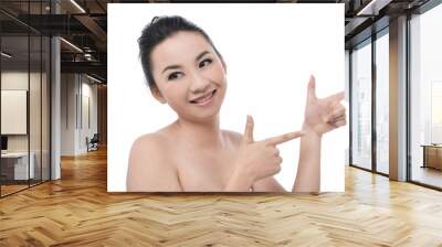 Portrait of smiling woman with two index fingers Wall mural