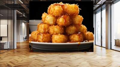 Front view of Crispy tater tots with savory salty spices on wooden table with black and blur background Wall mural