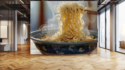 Noodles being cooked in a blue and white bowl with chopsticks. Wall mural