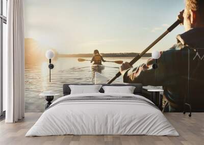 Kayak, lake and people rowing a boat on the water during summer for recreation or leisure at sunset. Nature, view and horizon with people canoeing for adventure, freedom or travel while on vacation Wall mural