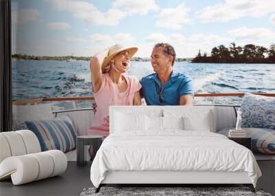 Laughing, happy couple and on a boat for retirement travel, summer freedom and holiday in Bali. Smile, love and a senior man and woman on a yacht for vacation adventure, luxury and a cruise date Wall mural