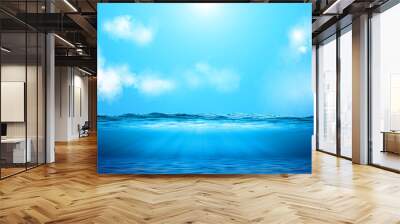 Realistic ocean underwater view, in the sunshine. Cloudy blue sky above the water. Wall mural