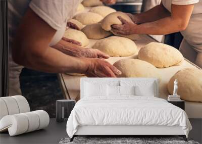 Bakers forming bread dough in a bakery Wall mural