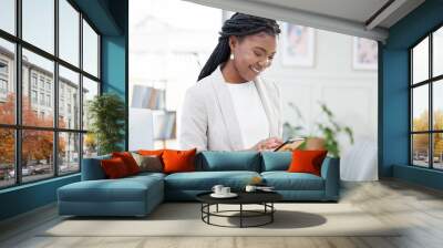 Black woman, typing and phone for business communication, chat and social media post in office. Happy african female entrepreneur reading email or review on smartphone app with network connection Wall mural