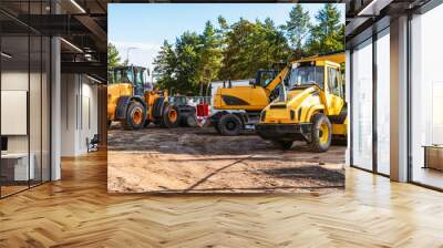 Heavy industrial machinery at construction site parking area Wall mural