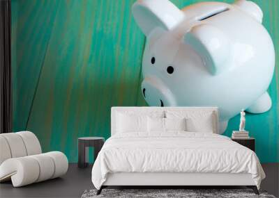 Piggy bank on the blue wooden surface Wall mural