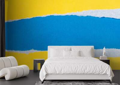 Torn yellow paper with a blue background Wall mural