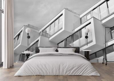  Fragment of a facade of a building with windows and balconies. Modern home with many flats. Black and white. Wall mural