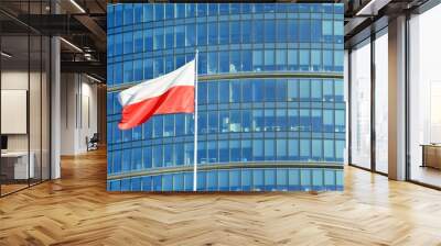  Polish flag on a pole waving, modern office building background Wall mural