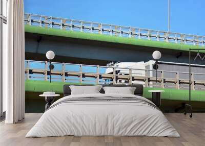 Bridge against the blue sky. Motorway flyover. Elevated roads on sunny day. Wall mural