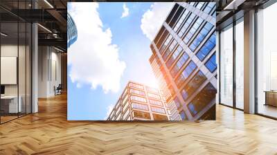 Glass facade of the buildings with a blue sky. Skyscrapers in the business city center.. Background of modern glass buildings.  Wall mural