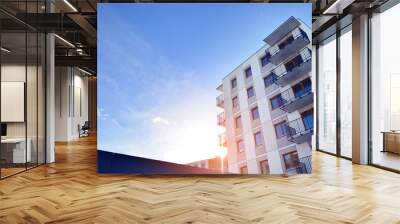 Modern apartment building in sunny day. Exterior, residential house facade. Residential area with modern, new and stylish living block of flats.  Wall mural