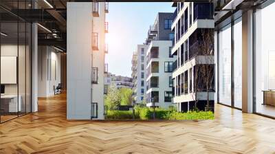 Modern apartment buildings on a sunny day with a blue sky. Facade of a modern apartment building. Contemporary residential building exterior in the daylight.  Wall mural