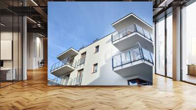 Modern apartment buildings on a sunny day with a blue sky. Facade of a modern apartment building.Glass surface with sunlight. Wall mural