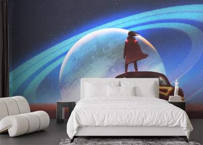 night scenery of the man standing on a vintage car looking at the planet with rings on a horizon, digital art style, illustration painting Wall mural