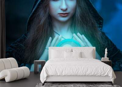 The witch with magic ball in her hands causes a spirits Wall mural