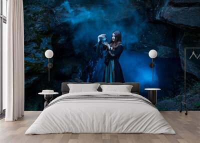 The witch with magic ball in her hands causes a spirits Wall mural