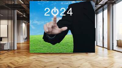 Businessman pressing 2024 start up business flat icon over green grass field with blue sky, Business happy new year 2024 success concept Wall mural