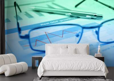 glasses and pen on blue financial chart and graph, success conce Wall mural