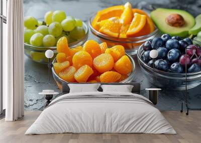 A bowl of oranges sits next to a bowl of blueberries and a bowl of grapes Wall mural