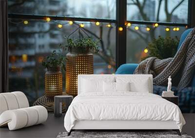 A cozy living room with a blue couch and two vases with candles on a table Wall mural