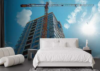 A crane is lifting a building under construction Wall mural