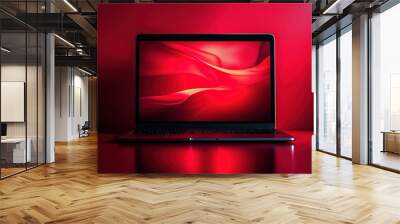 A laptop with a red background is turned on Wall mural