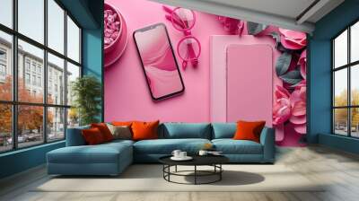 A pink phone and a pink book sit on a pink table Wall mural