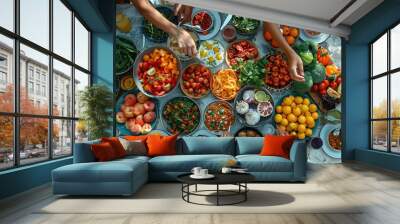 A table full of food with a group of people gathered around it Wall mural